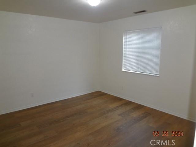 spare room featuring dark hardwood / wood-style flooring