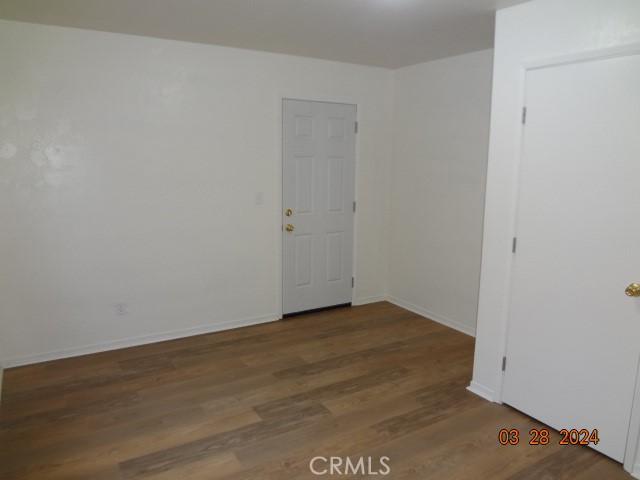 spare room featuring wood-type flooring