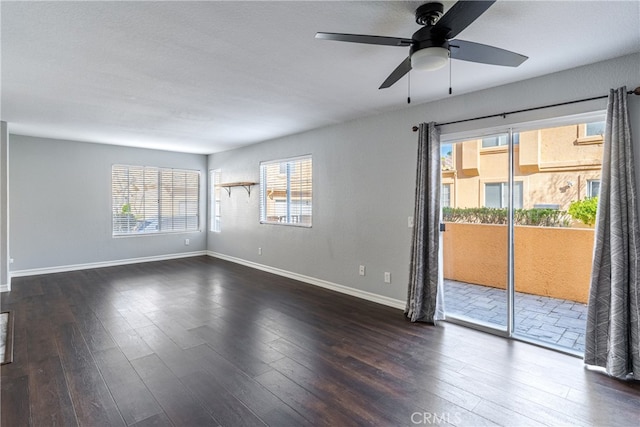 spare room with dark wood-type flooring and ceiling fan