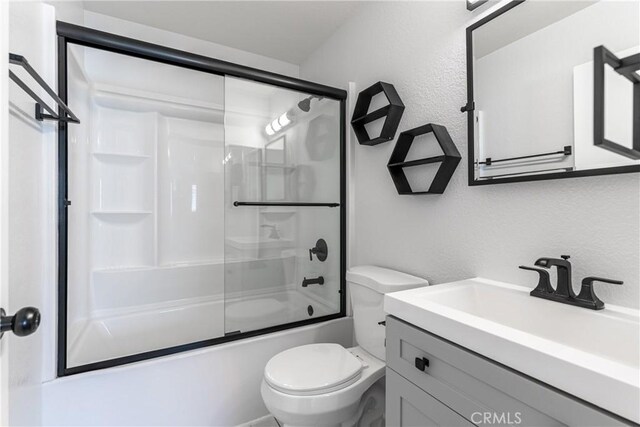 18840 Vista Del Canon Unit A, Newhall, CA 91321 - full bathroom with a textured wall, toilet, vanity, and bath / shower combo with glass door