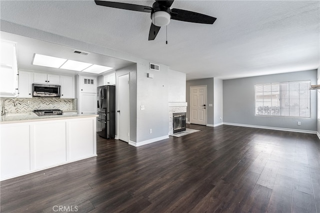 kitchen featuring white cabinets, ceiling fan, dark hardwood / wood-style floors, sink, and stainless steel appliances