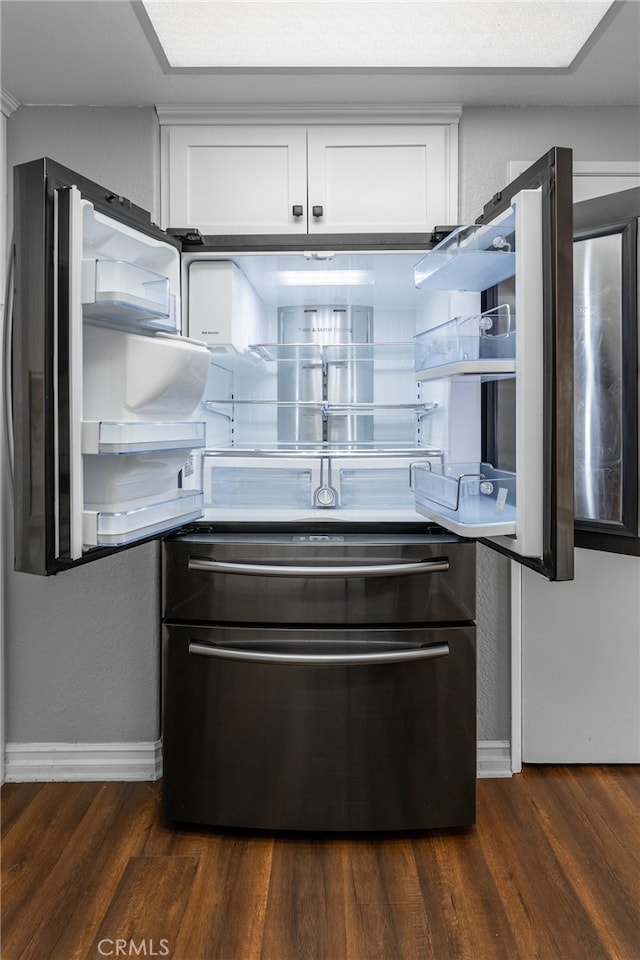 kitchen with dark hardwood / wood-style floors and white cabinets