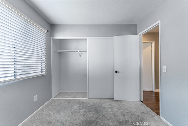 unfurnished bedroom featuring a closet and carpet flooring