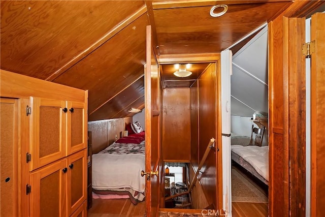 bedroom with wooden ceiling and wood finished floors