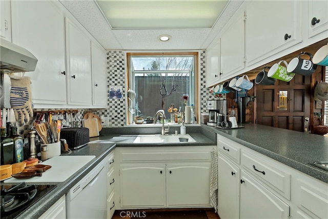 kitchen with decorative backsplash, white cabinets, white dishwasher, and sink