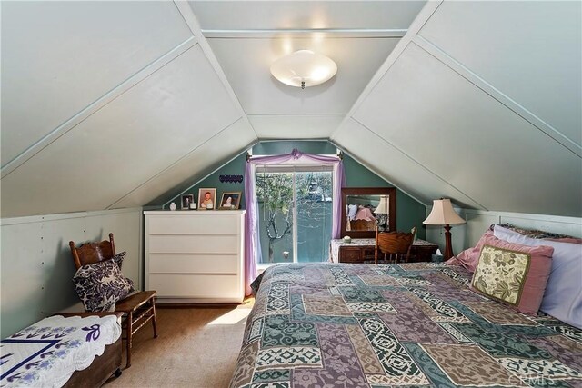 carpeted bedroom with lofted ceiling