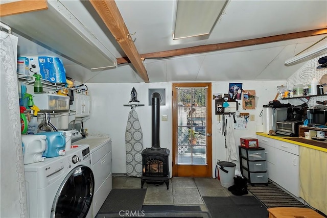 laundry area featuring a wood stove, laundry area, and washing machine and dryer