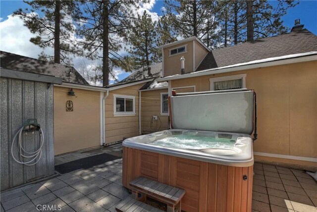 view of patio / terrace with a hot tub