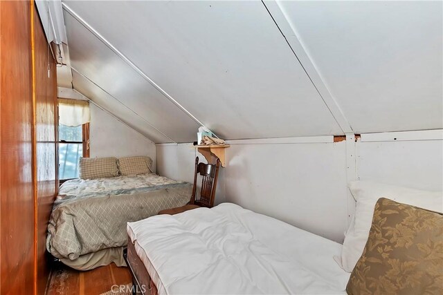 bedroom featuring vaulted ceiling and hardwood / wood-style floors