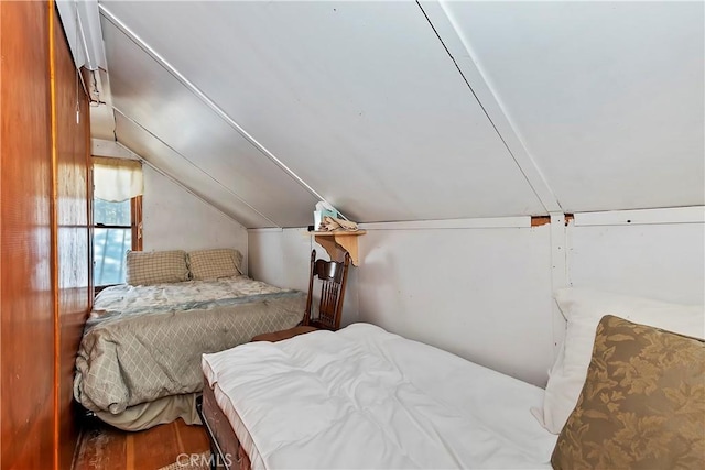 bedroom featuring vaulted ceiling and wood finished floors