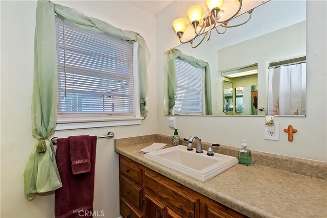 bathroom with vanity and a notable chandelier