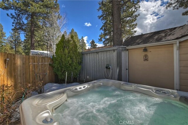 view of pool with a hot tub