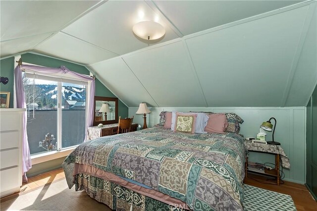 bedroom featuring wood-type flooring and vaulted ceiling