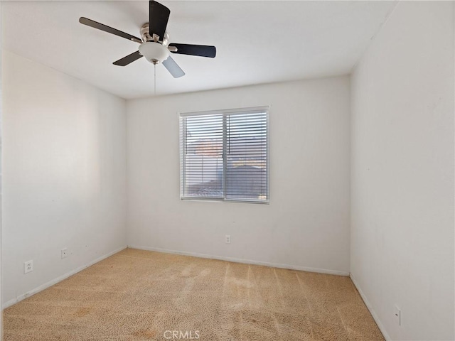 unfurnished room with ceiling fan and light carpet