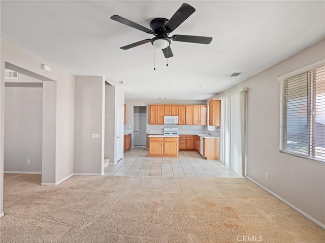 kitchen with light carpet and ceiling fan