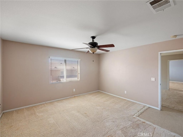 spare room featuring ceiling fan and light carpet