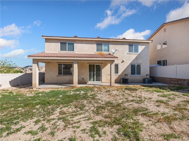 rear view of property featuring a patio area and central air condition unit