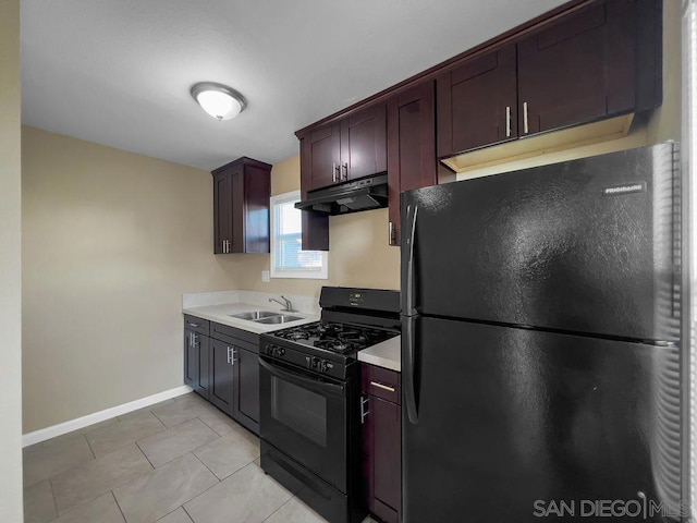 kitchen featuring dark brown cabinetry, light tile patterned floors, sink, and black appliances