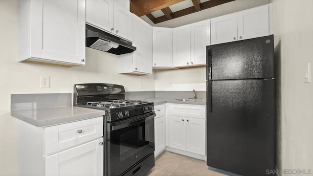 kitchen featuring sink, white cabinets, and black appliances