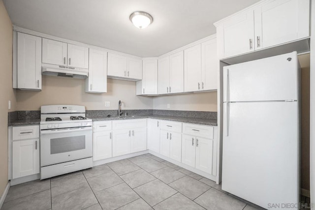 kitchen with white appliances, white cabinetry, light tile patterned floors, and sink