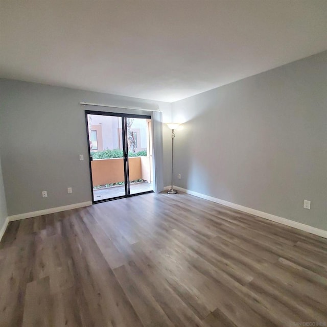 unfurnished room featuring dark hardwood / wood-style flooring