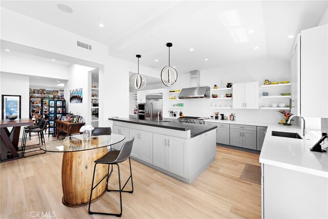 17 Monaco, Newport Beach, CA 92660 - kitchen featuring wall chimney range hood, open shelves, built in refrigerator, a sink, and recessed lighting
