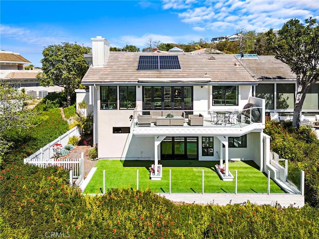 17 Monaco, Newport Beach, CA 92660 - back of property featuring a sunroom, roof mounted solar panels, stucco siding, and a chimney