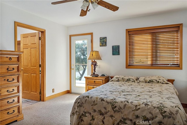 carpeted bedroom with multiple windows, ceiling fan, and access to exterior