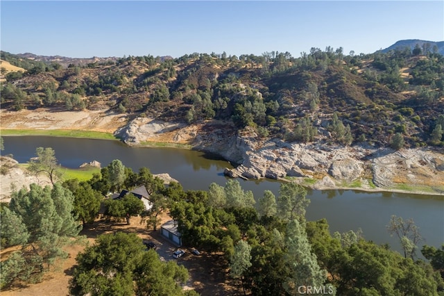 drone / aerial view featuring a water and mountain view