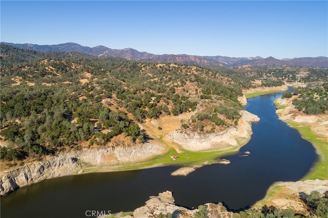 drone / aerial view featuring a water and mountain view
