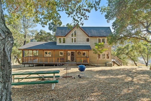 back of house with central AC unit