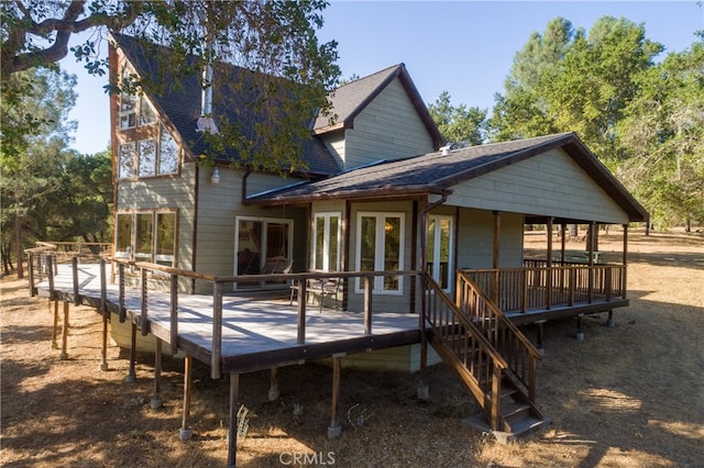 rear view of property with a deck and french doors