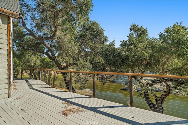 wooden deck featuring a water view