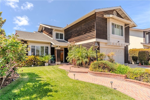 view of front of house with a front lawn and a garage