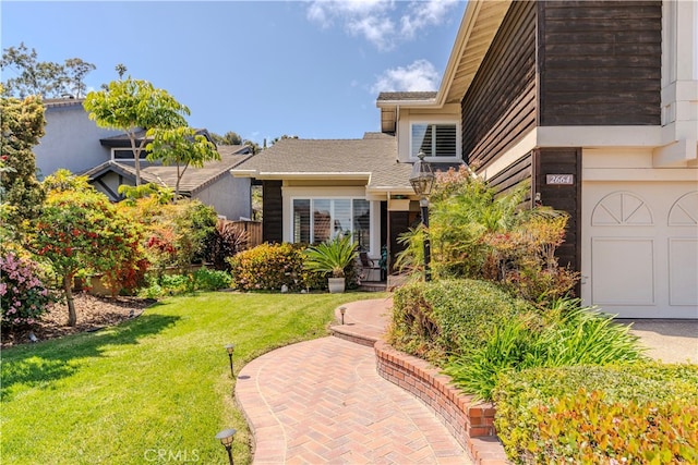 exterior space featuring a lawn and a garage