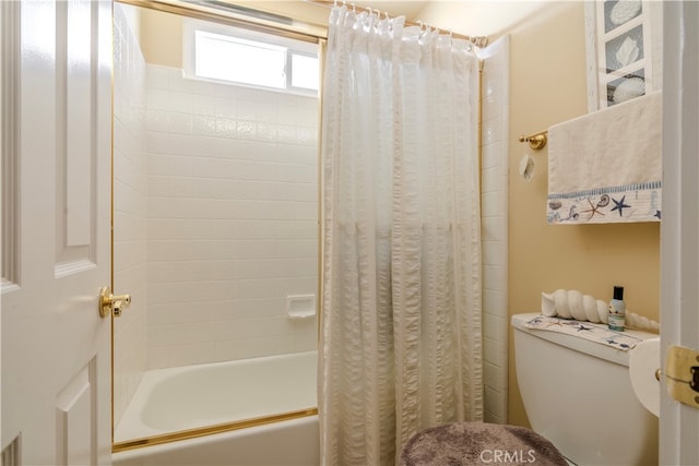 bathroom featuring toilet and shower / tub combo with curtain