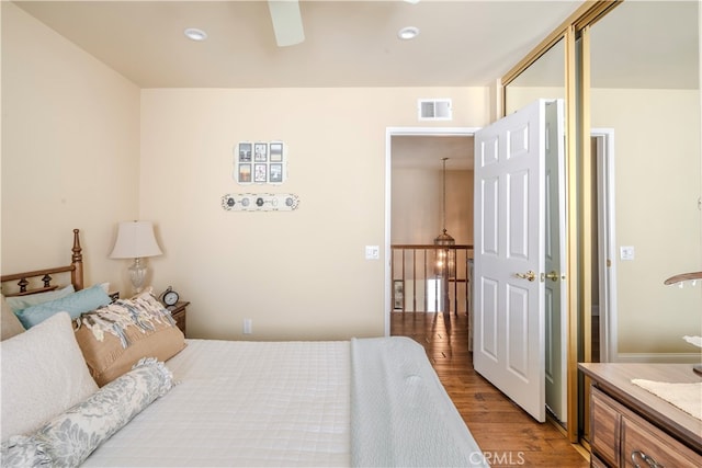 bedroom with wood-type flooring and ceiling fan