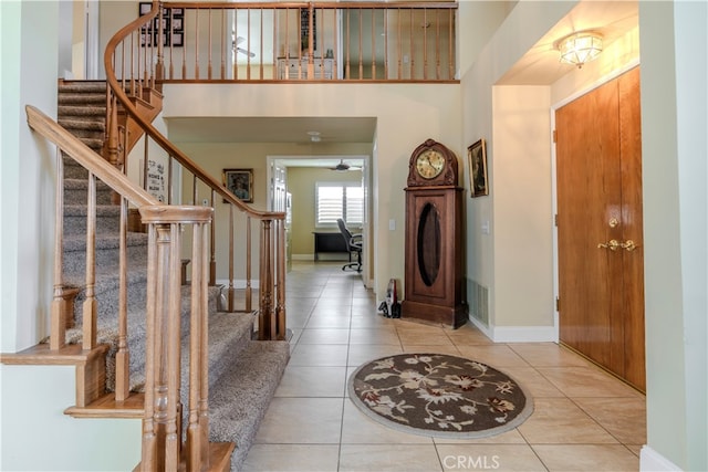 tiled entryway with a towering ceiling