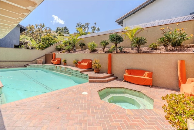 view of swimming pool with an in ground hot tub and a patio area