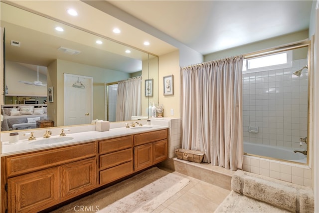 bathroom with shower / bath combo, tile patterned flooring, vanity, and ceiling fan