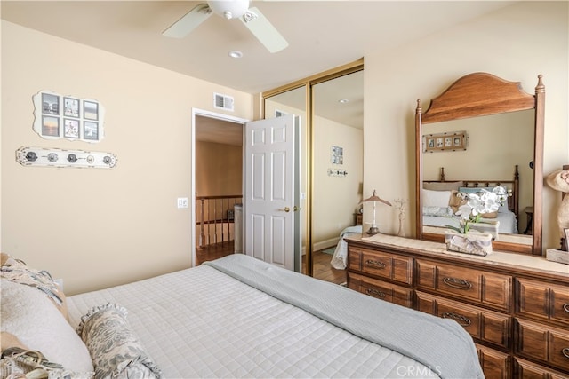 bedroom with ceiling fan, hardwood / wood-style flooring, and a closet