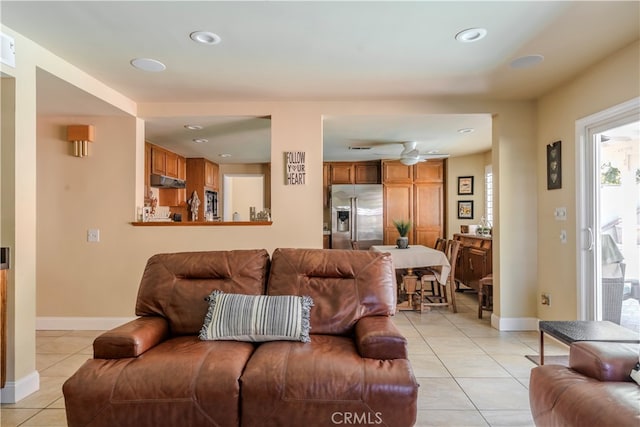 tiled living room with ceiling fan