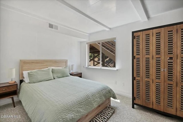 bedroom with light carpet and beam ceiling