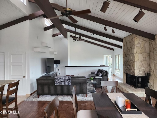 living room featuring light hardwood / wood-style floors, high vaulted ceiling, beam ceiling, and ceiling fan