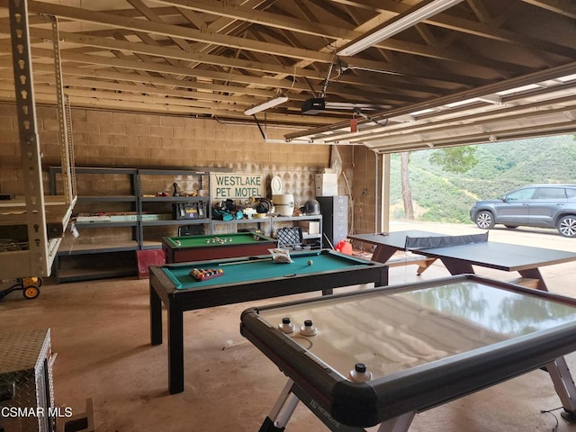 game room with billiards, a hot tub, and concrete flooring