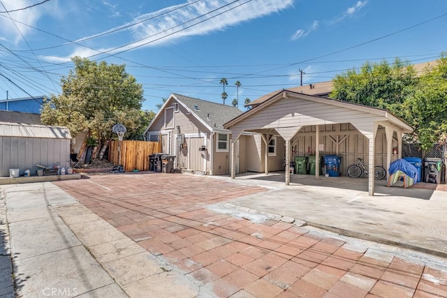 back of property with a carport