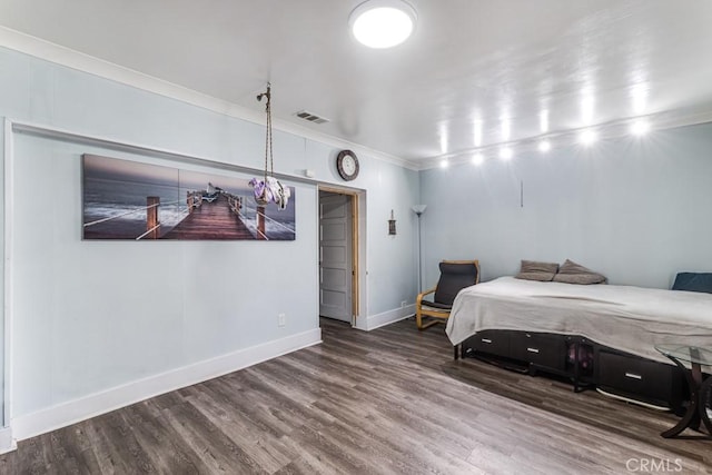 bedroom featuring hardwood / wood-style floors and ornamental molding