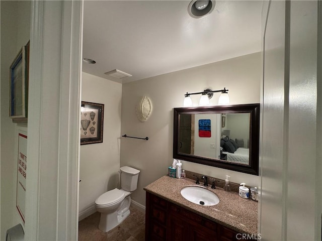 bathroom with toilet and vanity