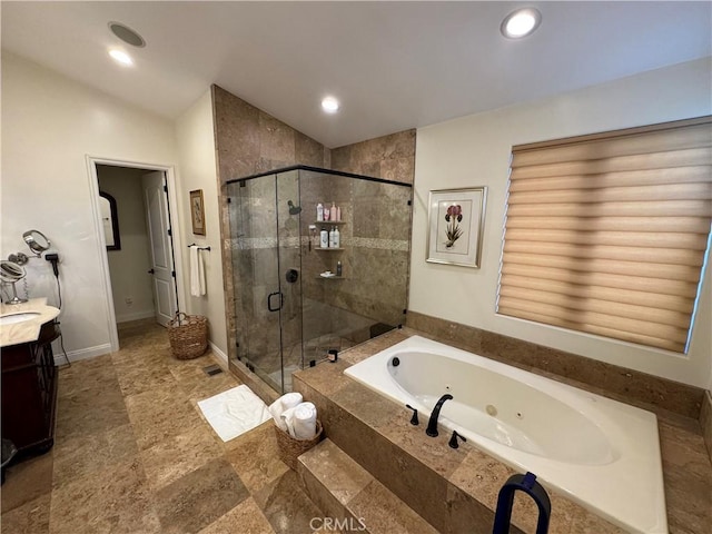 bathroom with vanity, vaulted ceiling, and independent shower and bath