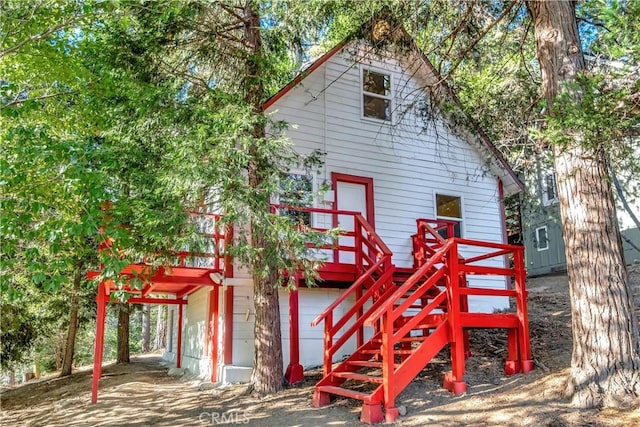 exterior space featuring a garage and a wooden deck